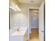 Bright bathroom with modern vanity, quartz countertop, and decorative lighting fixture at 17714 Everlong Dr, Land O Lakes, FL 34638
