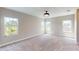 Sunlit bedroom featuring neutral carpet and multiple windows for natural light at 17714 Everlong Dr, Land O Lakes, FL 34638