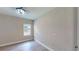 Bright bedroom with wood floors, natural light from window, and modern light fixture at 17714 Everlong Dr, Land O Lakes, FL 34638