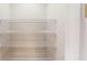 Empty closet featuring multiple wire shelves offering ample storage space at 17714 Everlong Dr, Land O Lakes, FL 34638