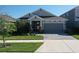 Charming home features a manicured lawn and a paved driveway at 17714 Everlong Dr, Land O Lakes, FL 34638