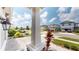 A view of neighborhood homes from under the covered front porch at 17714 Everlong Dr, Land O Lakes, FL 34638