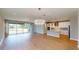 Open-concept kitchen showcasing quartz countertops, stainless steel appliances, and view of the living area at 17714 Everlong Dr, Land O Lakes, FL 34638