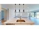 Modern kitchen island with stainless steel sink and view of the great room at 17714 Everlong Dr, Land O Lakes, FL 34638