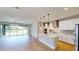 Modern kitchen featuring an island, stainless steel appliances, and an open view to the dining area at 17714 Everlong Dr, Land O Lakes, FL 34638