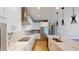 Modern kitchen with stainless steel appliances, gas cooktop, quartz countertops, and white cabinetry at 17714 Everlong Dr, Land O Lakes, FL 34638