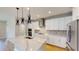 Well-equipped kitchen with white cabinetry, stainless steel appliances, and a center island at 17714 Everlong Dr, Land O Lakes, FL 34638