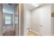Upstairs hallway featuring access to a laundry room with shelving and washer/dryer hookups at 17714 Everlong Dr, Land O Lakes, FL 34638