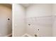 Bright laundry room with wood floors, shelving and washer and dryer hookups at 17714 Everlong Dr, Land O Lakes, FL 34638