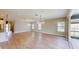 Bright, open-concept living room with light wood flooring and sliding door access to the patio at 17714 Everlong Dr, Land O Lakes, FL 34638