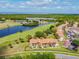 Aerial view of condo community with lake, golf course, and lush greenery; beautiful waterfront property at 1967 Cormorant Ct # 515, Clearwater, FL 33762