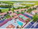 Aerial view of a community featuring tennis courts, swimming pool and lush landscaping at 1967 Cormorant Ct # 515, Clearwater, FL 33762