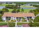 Aerial view of condos near a golf course and lake, featuring mature trees and landscaping at 1967 Cormorant Ct # 515, Clearwater, FL 33762