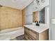 Bathroom with cream tiles, modern vanity, mirror, and bathtub/shower combo at 1967 Cormorant Ct # 515, Clearwater, FL 33762