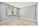 Empty bedroom shows the light gray walls and wood look laminate floor at 1967 Cormorant Ct # 515, Clearwater, FL 33762