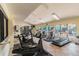 Community fitness center featuring cardio equipment, weights, and large windows at 1967 Cormorant Ct # 515, Clearwater, FL 33762