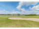 Scenic golf course view featuring manicured greens, a sand trap, and lake at 1967 Cormorant Ct # 515, Clearwater, FL 33762