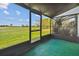 View from the screened lanai overlooking the lush green golf course and sunny blue sky at 1967 Cormorant Ct # 515, Clearwater, FL 33762