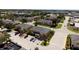 Aerial view displaying well-maintained landscaping, street parking, a playground, and nearby commercial area at 2007 Searay Shore Dr, Clearwater, FL 33763