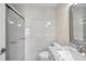 Updated bathroom with gray marble vanity, toilet, and glass enclosed shower with modern hardware at 2007 Searay Shore Dr, Clearwater, FL 33763