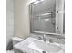 Bathroom featuring a marble countertop, a large mirror, and a tiled shower with glass doors at 2007 Searay Shore Dr, Clearwater, FL 33763