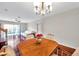 Inviting dining room featuring hardwood floors, elegant chandelier, and decorative vase at 2007 Searay Shore Dr, Clearwater, FL 33763