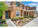 Inviting townhome featuring colorful landscaping, a teal front door, and complementary window shutters at 2007 Searay Shore Dr, Clearwater, FL 33763