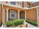 Charming townhome entrance featuring manicured landscaping, a covered porch, and classic architectural details at 2007 Searay Shore Dr, Clearwater, FL 33763