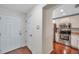 Bright hallway showcasing a front door, access to the kitchen, and hardwood floors at 2007 Searay Shore Dr, Clearwater, FL 33763