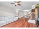 Spacious living room featuring hardwood floors, staircase, and comfortable white leather seating at 2007 Searay Shore Dr, Clearwater, FL 33763