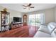 Bright living room boasts hardwood floors, comfortable seating, and access to the backyard at 2007 Searay Shore Dr, Clearwater, FL 33763