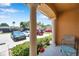 Covered patio area showcases a seating area and view of the parking area and community playground at 2007 Searay Shore Dr, Clearwater, FL 33763