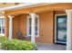 Inviting porch showcasing classic pillars, beautiful landscaping, seating, and view of common parking at 2007 Searay Shore Dr, Clearwater, FL 33763