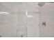 Modern shower with white marble tile, glass door, and rainfall shower head at 2007 Searay Shore Dr, Clearwater, FL 33763
