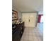 A foyer with neutral walls, white tile flooring, a dark sideboard and double entry doors at 2043 Sugarbush Dr, Holiday, FL 34690