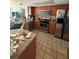A spacious kitchen with stainless steel appliances, tile backsplash, and stone countertops at 2043 Sugarbush Dr, Holiday, FL 34690