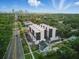 New townhomes with an eye-catching design next to a main road, surrounded by a mix of homes and lush trees at 2120 4Th S St, St Petersburg, FL 33705