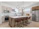 Modern kitchen boasts stainless steel appliances, sleek countertops, and a center island with seating at 2120 4Th S St, St Petersburg, FL 33705