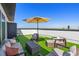 Relax on the rooftop deck with outdoor seating, artificial turf, and an umbrella for shade at 2120 4Th S St, St Petersburg, FL 33705