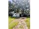 Backyard featuring a shed and metal support structure and mature trees at 2414 S 67Th St, Tampa, FL 33619