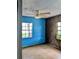 Bedroom featuring hardwood floors, windows for natural light, and blue walls at 2414 S 67Th St, Tampa, FL 33619