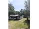 Modest home with covered porch and large trees creating a shaded yard at 2414 S 67Th St, Tampa, FL 33619