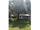 Quaint home nestled beneath a large shade tree in an expansive lawn at 2414 S 67Th St, Tampa, FL 33619