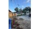 The backyard has sparse grass, a fence line and mature trees at 2518 Mabry St, Tampa, FL 33618