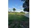 Grassy yard beside a pond and framed by trees at 2518 Mabry St, Tampa, FL 33618