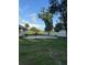 This backyard includes a concrete patio and untamed grass leading to a white fence, promising space and privacy at 2518 Mabry St, Tampa, FL 33618
