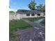 Simple one story house with overgrown landscape and weathered driveway at 2518 Mabry St, Tampa, FL 33618