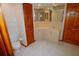 Bathroom featuring a toilet and sink with cabinets, a mirror, and wood trim at 2784 Alexander Dr, Clearwater, FL 33763