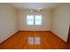 Bright bedroom with hardwood floors, ceiling fan, and natural light from the double window at 2784 Alexander Dr, Clearwater, FL 33763