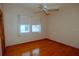 Bright bedroom with hardwood floors, ceiling fan, and natural light from the double window at 2784 Alexander Dr, Clearwater, FL 33763